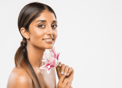 Beauty Woman Face Skin Care. Happy Smiling Indian Girl with Natural Lips and Eyes Make up over White isolated. Women Body Care and Facial Spa Treatment Cosmetics | Adam J Cohen, MD in Glenview & Chicago, IL