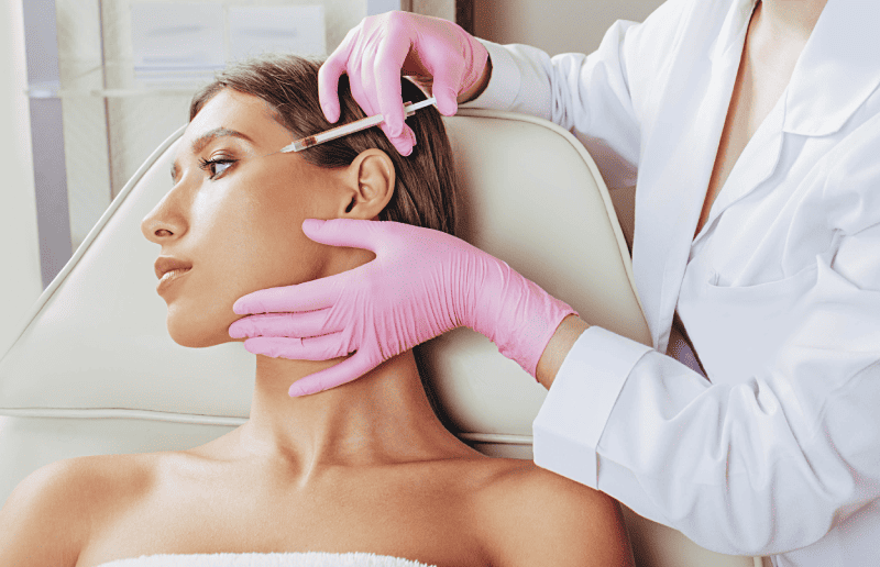 Botulinum toxin injections in forehead. Anti aging procedure after 30 years, cosmetologist making injection | Adam J Cohen, MD in Glenview & Chicago, IL