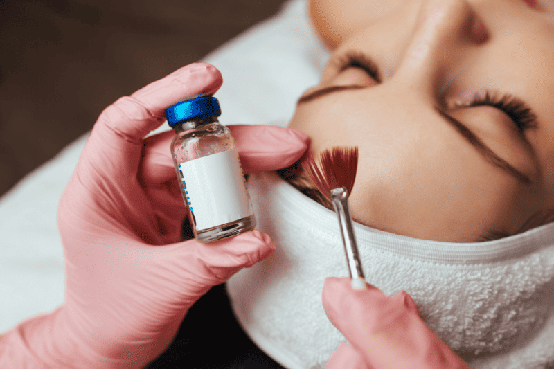 In the hands of a brush and a container with the drug, cosmetology chemical peeling | Adam J Cohen, MD in Glenview & Chicago, IL