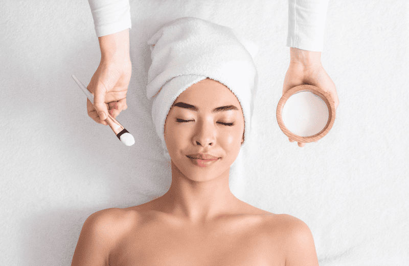 Relaxed Asian Woman Lying On Spa Table Ready For Facial Beauty | Adam J Cohen, MD in Glenview & Chicago, IL